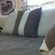 Make a twin-sized bed look more like a couch with a duvet cover and some custom pillows. 