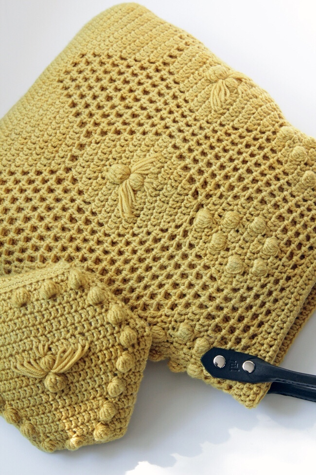 Crochet the Worker Bee Bag & Worker Bee Clutch during the Read Along Crochet Along, April 1-30! This adorable bag uses filet crochet, baubles, and elongated stitches to create a fun, textural piece perfect for spring!