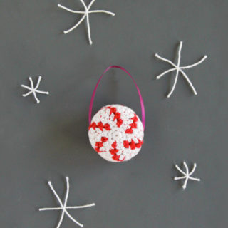 A free crochet pattern for a quick and festive peppermint ornament. Click through for the free pattern!