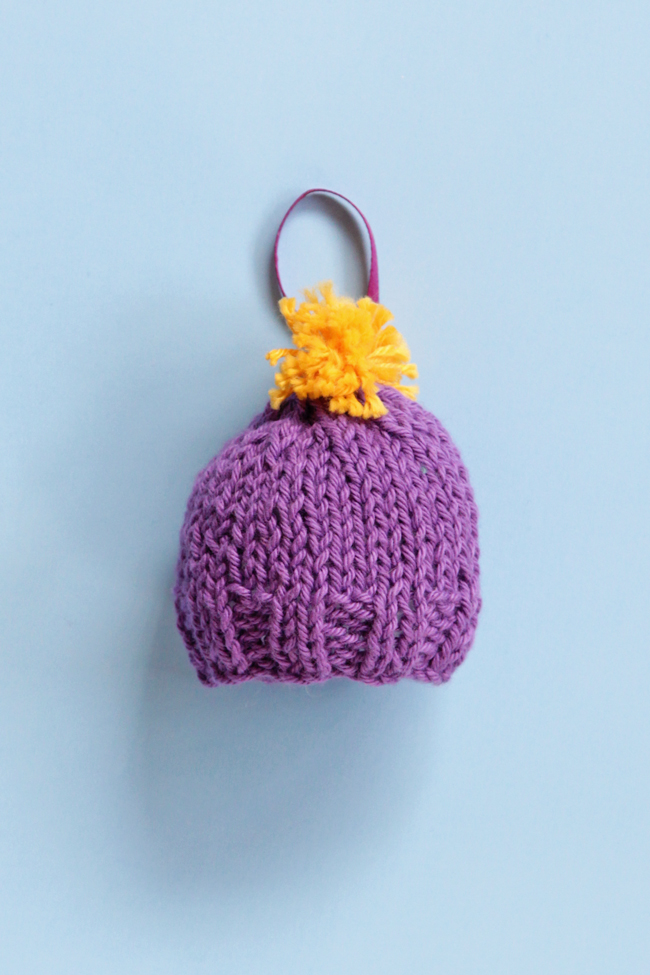 Get a free pattern for this mini knit beanie, which works great for holiday ornaments or as a gift topper!