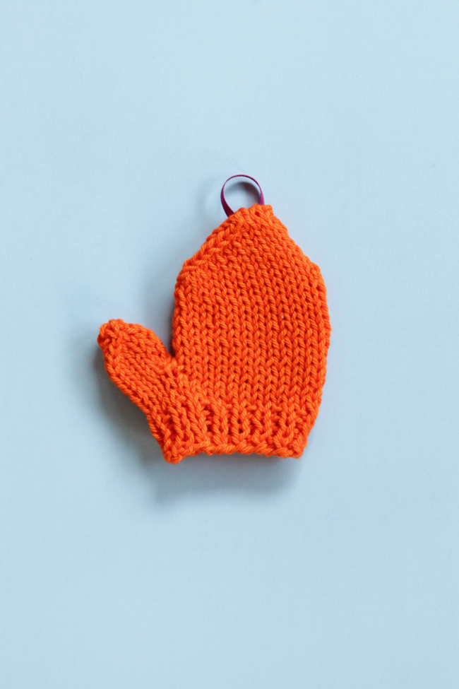 Get a free pattern for this mini knit mitten, which works great for holiday ornaments or as a gift topper!