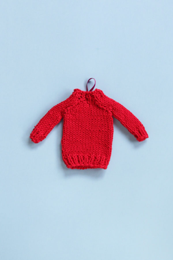 Get a free pattern for this mini knit sweater, which works great for doll clothes, holiday ornaments or as a gift topper!