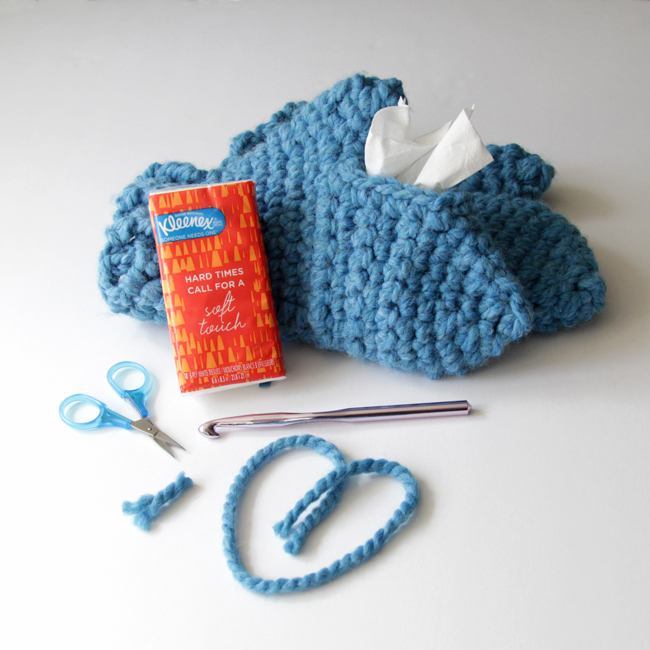 With these mittens, you can keep your hands cozy while keeping Kleenex tissues close at hand! Simply make one traditional mitten, then crochet its mate with an opening to fit a Kleenex Go Pack on top of your hand. These chunky mittens can fit either hand, depending on where its most convenient for you to keep your tissues during sniff season. 