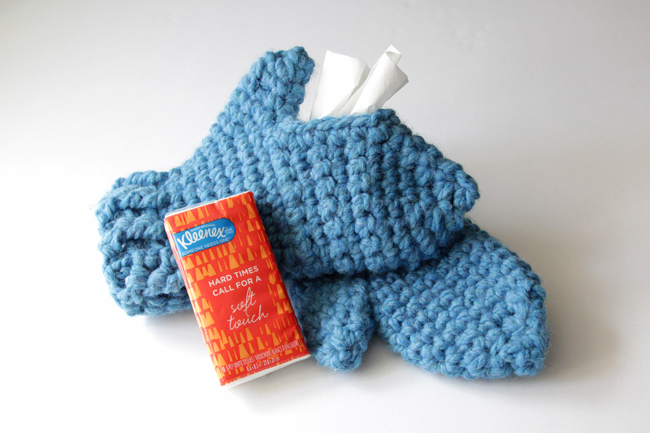 With these mittens, you can keep your hands cozy while keeping Kleenex tissues close at hand! Simply make one traditional mitten, then crochet its mate with an opening to fit a Kleenex Go Pack on top of your hand. These chunky mittens can fit either hand, depending on where its most convenient for you to keep your tissues during sniff season. 