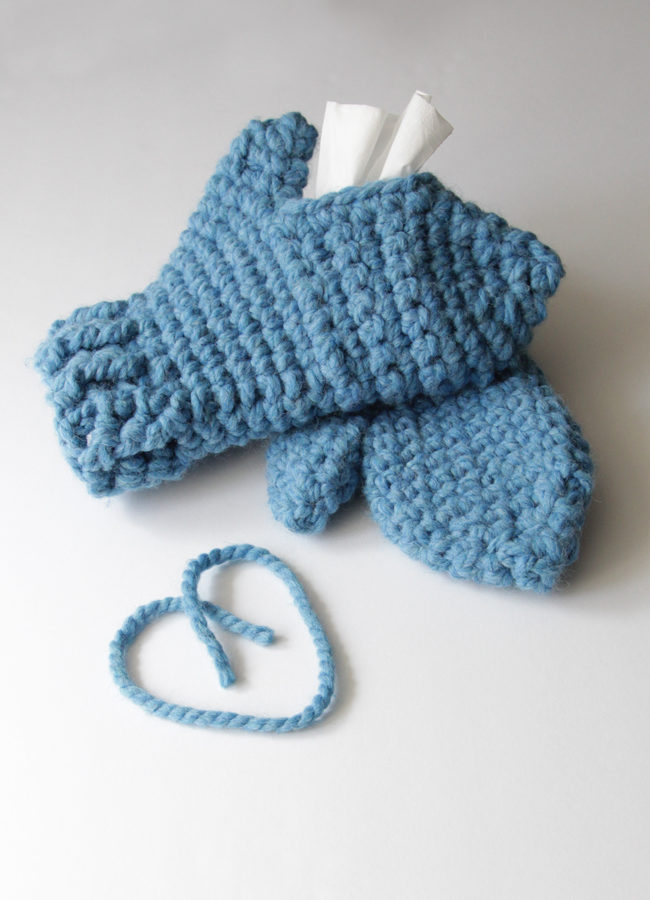 With these mittens, you can keep your hands cozy while keeping Kleenex tissues close at hand! Simply make one traditional mitten, then crochet its mate with an opening to fit a Kleenex Go Pack on top of your hand. These chunky mittens can fit either hand, depending on where its most convenient for you to keep your tissues during sniff season.