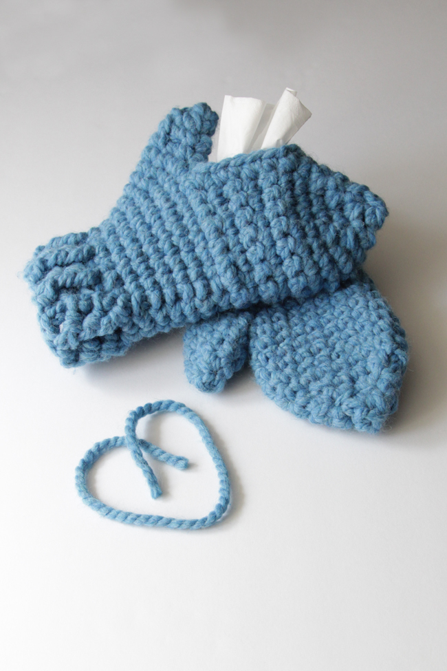 With these mittens, you can keep your hands cozy while keeping Kleenex tissues close at hand! Simply make one traditional mitten, then crochet its mate with an opening to fit a Kleenex Go Pack on top of your hand. These chunky mittens can fit either hand, depending on where its most convenient for you to keep your tissues during sniff season. 