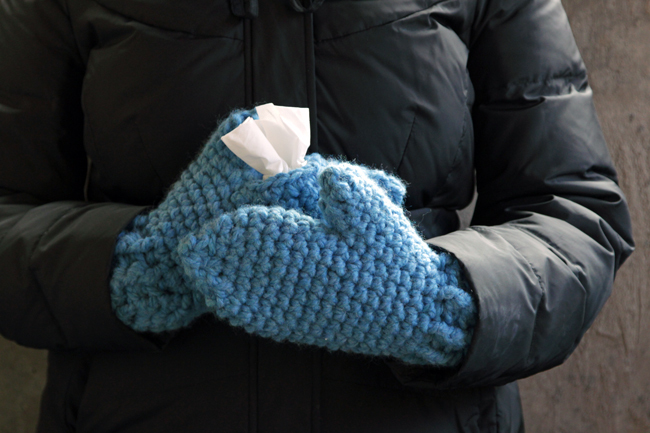 With these mittens, you can keep your hands cozy while keeping Kleenex tissues close at hand! Simply make one traditional mitten, then crochet its mate with an opening to fit a Kleenex Go Pack on top of your hand. These chunky mittens can fit either hand, depending on where its most convenient for you to keep your tissues during sniff season. 