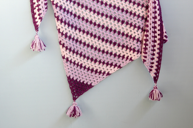 This granny square-inspired crochet shawl is super fun to make because once you memorize how to work its easy stitch pattern, you can go to town until it's the size you want, or until you run out of yarn. A shawl like this one is the perfect way to show off your tassel skills, too! 