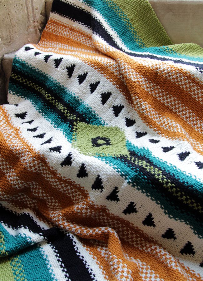 The Arizona Afghan is a single panel blanket inspired by iconic woven blankets of the American Southwest. The bold, graphic design of this throw is accomplished through a combination of linen stitch, stranded colorwork, slipped stitches and a dash of intarsia. Get the pattern in I Like Knitting magazine.