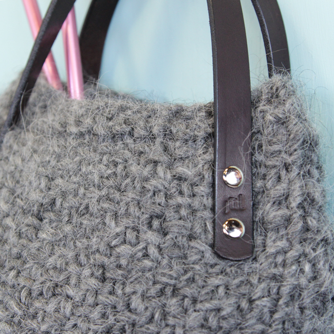 The Lopi Tote makes use of bulky yarn and elegant, screw-in handles to create a deep bag with a wide base that knits up quick. Get your hands on this free pattern, designed with knitters in mind. The Lopi Tote is perfect for carrying your next knitting project on the go! 