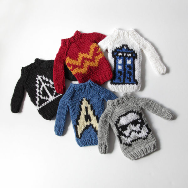 The Mini Fandom Sweaters Collection by Heidi Gustad, designed as part of Fandom Fiibers' inaugural collection and available exclusively in kits at C2E2 2018. Available as PDFs beginning April 9.