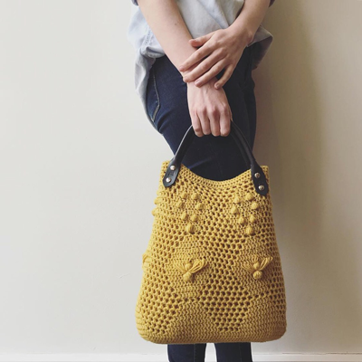 Crochet the Worker Bee Bag & Worker Bee Clutch! This adorable bag uses filet crochet, baubles, and elongated stitches to create a fun, textural piece perfect for spring!