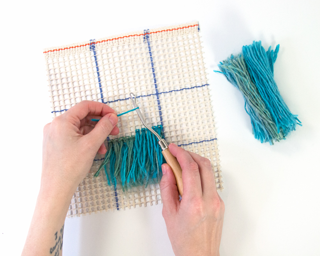 Learn how to latch hook with an easy-to-follow tutorial. Make wall hangings, throw pillows, rugs, and more! Latch hook projects are a great use for scrap yarn too.