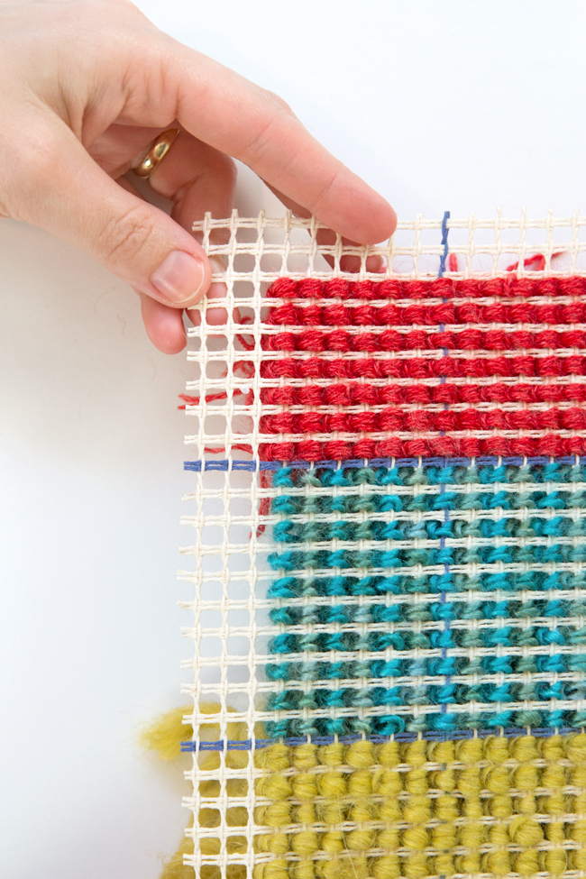 Learn how to latch hook with an easy-to-follow tutorial. Make wall hangings, throw pillows, rugs, and more! Latch hook projects are a great use for scrap yarn too.