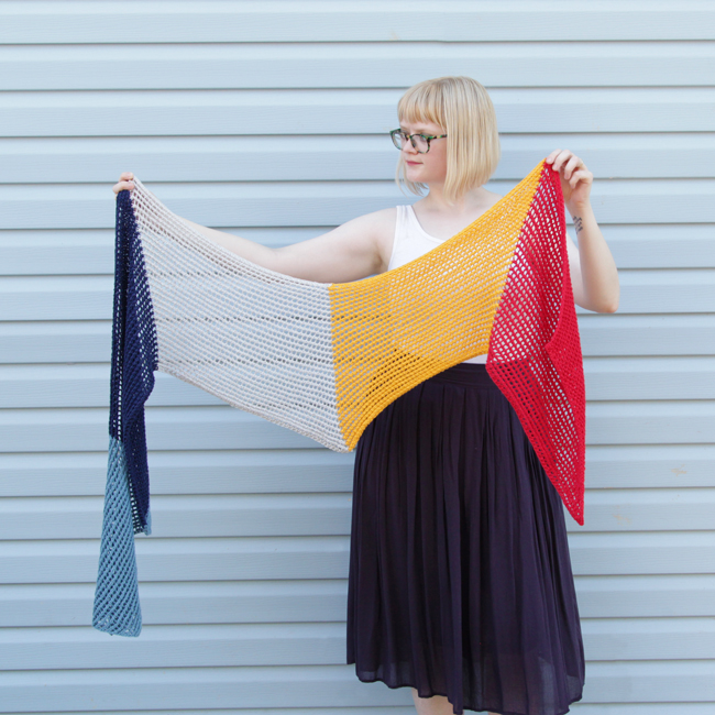 Who doesn't love an easy-to-knit, versatile pattern? The Wherever Wrap is a fun colorblock piece knit with a simple lace motif. Get the free knitting pattern by designer Heidi Gustad. 