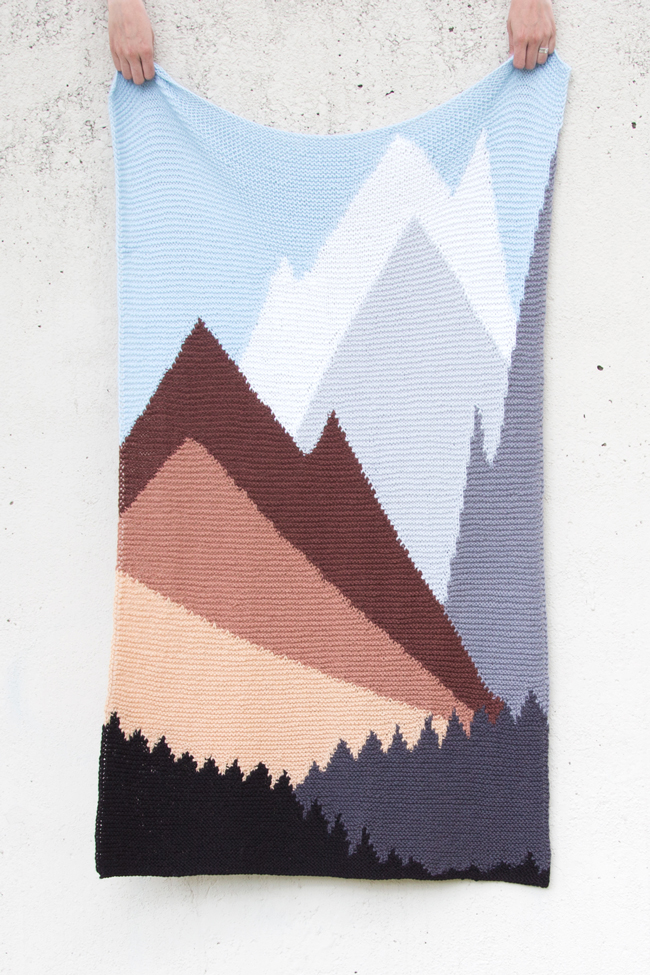 Intarsia Mountain by Heidi Gustad is a knitting pattern worked primarily in garter stitch and features a beautiful landscape formed using color and geometric lines.