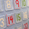 Scandinavian Advent Calendar - free crochet pattern -- An advent calendar is a great way to make your own keepsake Christmas decoration and build a family tradition for years to come. The Scandinavian Advent Calendar is great for crocheters at almost any skill level and is inspired by beautiful holiday decor found in Scandinavia. This pattern features basic embroidery stitches for added texture and a handmade look.