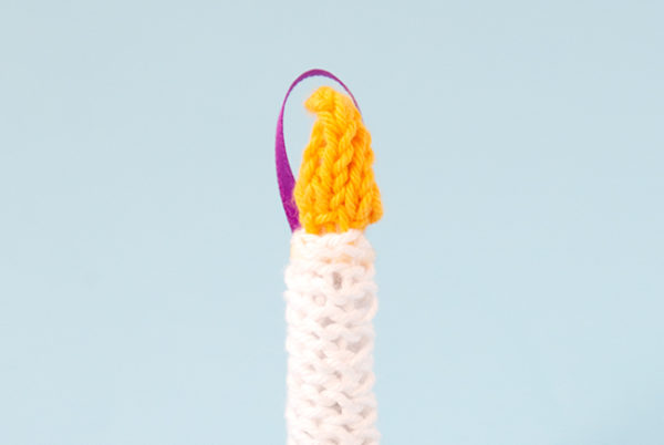 The Knit Candle Ornament can be easily made in under an hour, making it the perfect little finished object to shoe horn in during the busy Christmas season. Get the free pattern to light up your holiday!
