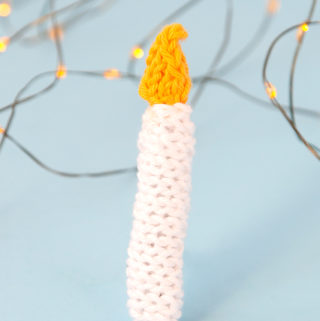 The Knit Candle Ornament can be easily made in under an hour, making it the perfect little finished object to shoe horn in during the busy Christmas season. Get the free pattern to light up your holiday!