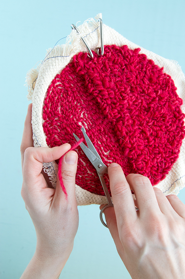 Weaving in your ends on a punch needle project is easy! Check out this step-by-step tutorial for tips and tricks for hiding and securing your punch needle rug hooking tails.