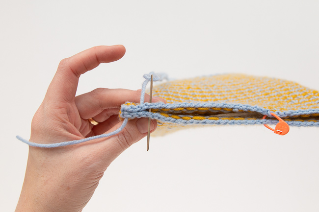 Knit up a simple tablet sleeve to protect your tablet from scratches on the go! The Comfy Tablet Sleeve knits up so quickly, making it a great gift-giving idea too. Get the free knitting pattern.