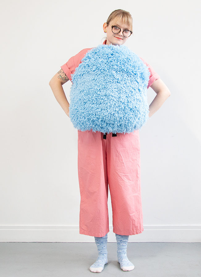 I got this wild idea to make a giant pom pom costume using latch hook, so I gave it a go for Halloween. Take a closer look at this three dimensional rug-making project and its construction.
