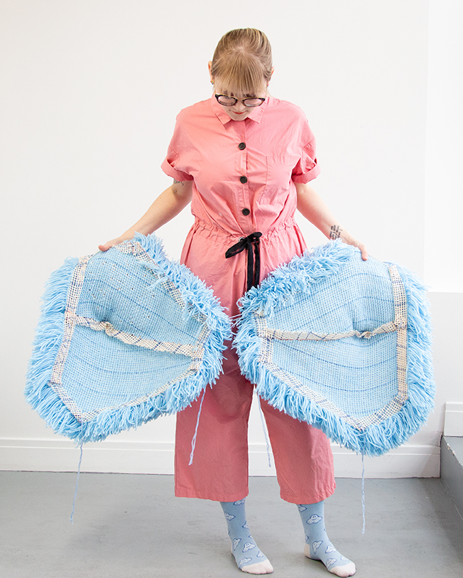 I got this wild idea to make a giant pom pom costume using latch hook, so I gave it a go for Halloween. Take a closer look at this three dimensional rug-making project and its construction.