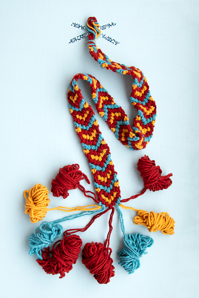 Make a giant friendship bracelet-inspired runner for your Friendsgiving table! Knotted with 100% American wool, this easy project doubles as a hostess gift and macramé scarf. Visit handsoccupied.com to learn how to make this easy Thanksgiving craft project. 