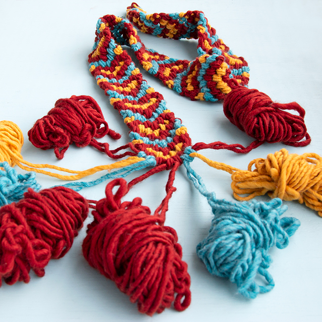 Make a giant friendship bracelet-inspired runner for your Friendsgiving table! Knotted with 100% American wool, this easy project doubles as a hostess gift and macramé scarf. Visit handsoccupied.com to learn how to make this easy Thanksgiving craft project. 