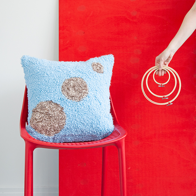 Learn how to make these planet-inspired punch needle throw pillows using embroidery hoops! 