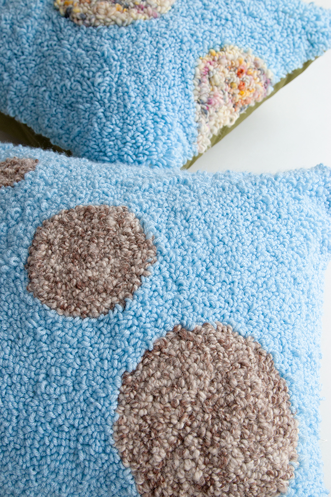 Learn how to make these planet-inspired punch needle throw pillows using embroidery hoops!