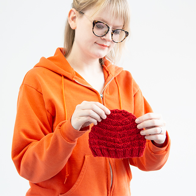 The Triangle Rib Baby Hat knits up so quickly! Get your hands on this free charity knitting pattern for babies on Hands Occupied. #charityknitting #freepattern #babyknitting