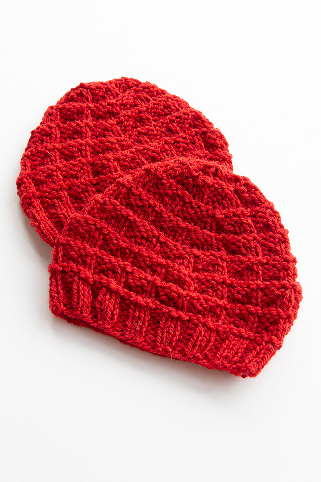 The Triangle Rib Baby Hat knits up so quickly! Get your hands on this free charity knitting pattern for babies on Hands Occupied. #charityknitting #freepattern #babyknitting