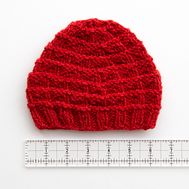 The Triangle Rib Baby Hat knits up so quickly! Get your hands on this free charity knitting pattern for babies on Hands Occupied. #charityknitting #freepattern #babyknitting