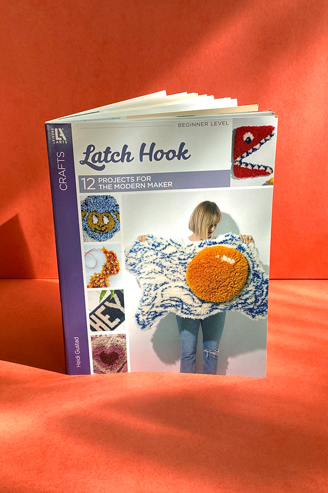 A copy of Latch Hook: 12 Projects for the Modern Maker (2020) by Heidi Gustad on a red background