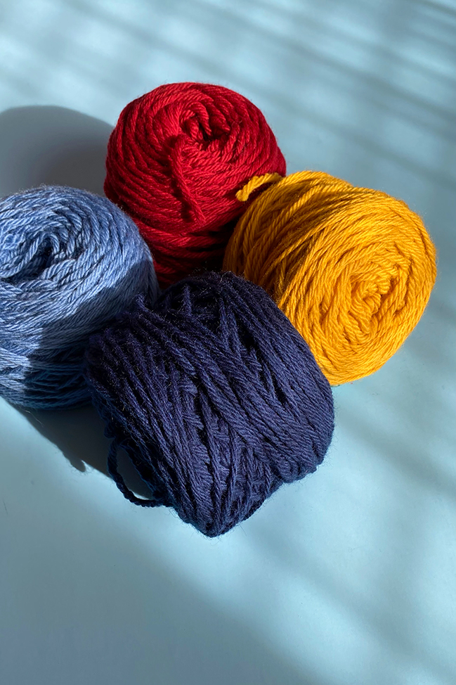 Four skeins of primary colored yarn used to help explain the concept of color value.