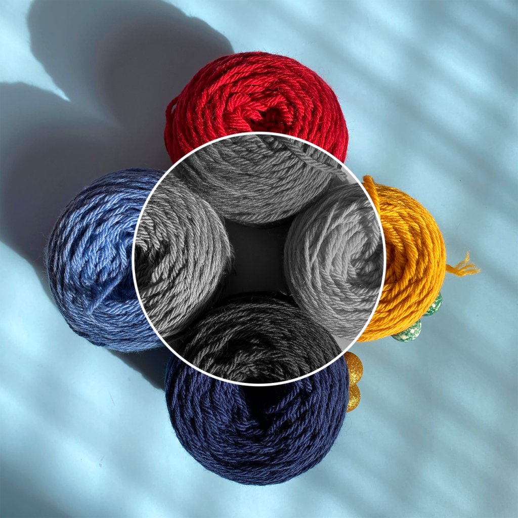 Four skeins of primary colored yarn in color as well as black and white, used to help explain the concept of color value.