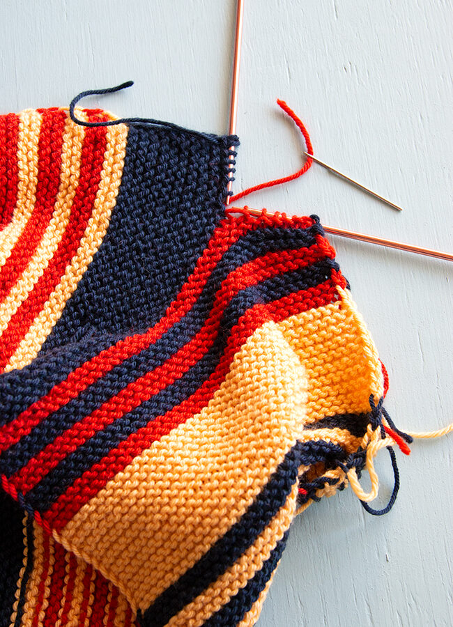 Join two pieces of garter stitch knitting invisibly with the kitchener stitch - learn how to do garter kitchener stitch. (with video!)