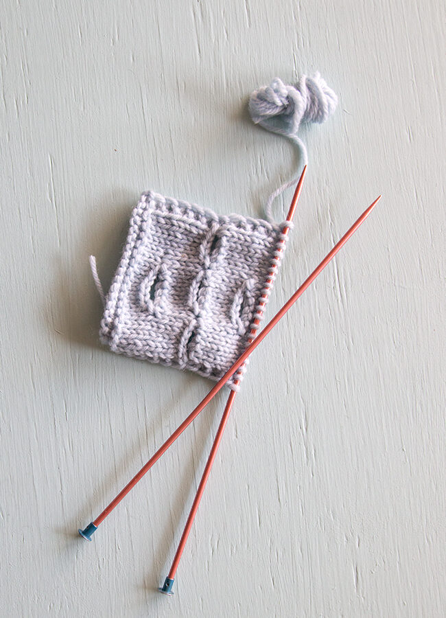 Learn how to knit a buttonhole over the course of a single row of knitting, also known as a one-row buttonhole. In this technique, a combination of binding off and casting on stitches on opposite sides of the work creates a symmetrical, stretchy buttonhole.