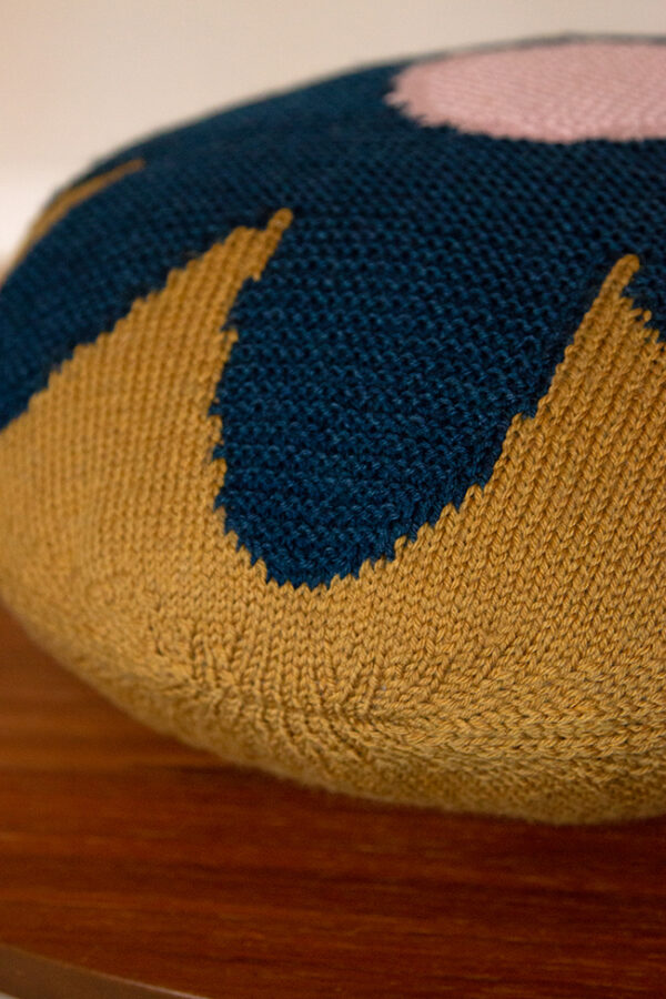 A detail shot of Intarsia Flower Pillow's seaming and combination of garter and stockinette stitch with intarsia.
